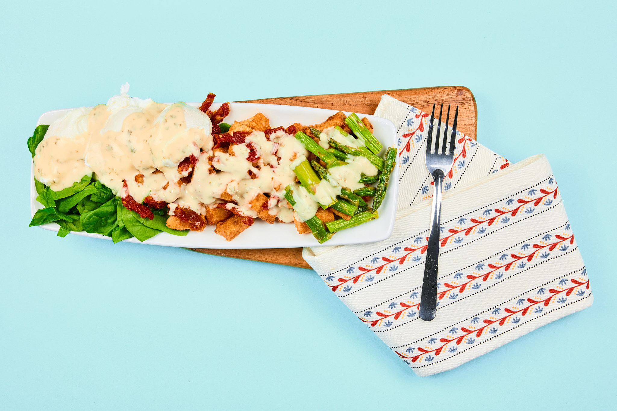 Sundried Tomato and Asparagus Benedict On Breakfast Potatoes